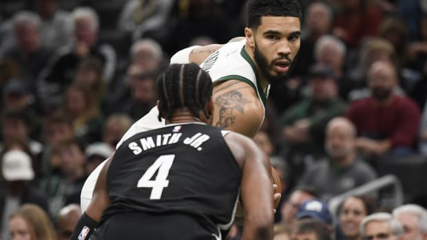 Boston Celtics forward Jayson Tatum (0) is guarded by Brooklyn Nets guard Dennis Smith Jr. (4)